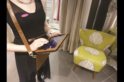 The store features staff with mobile tills on iPads